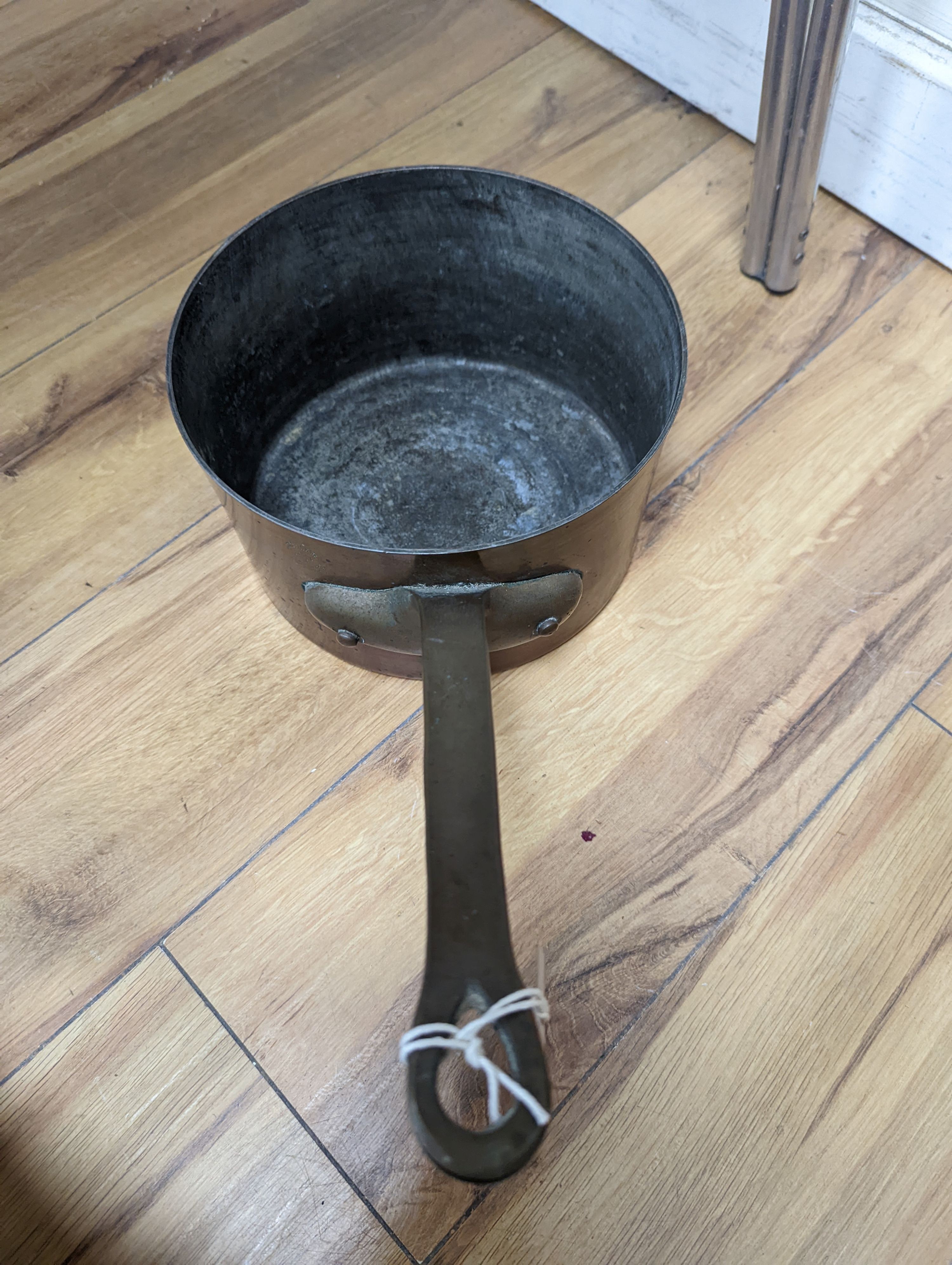 A group of three Jaeggi & Sons copper saucepans